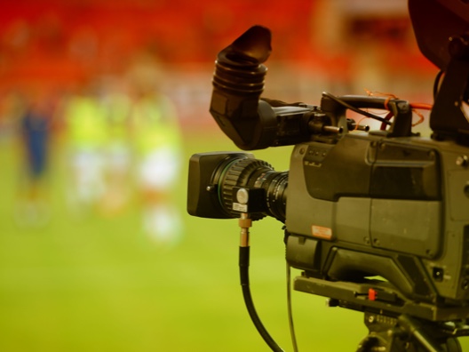 Sideview of professional video camera at sport event